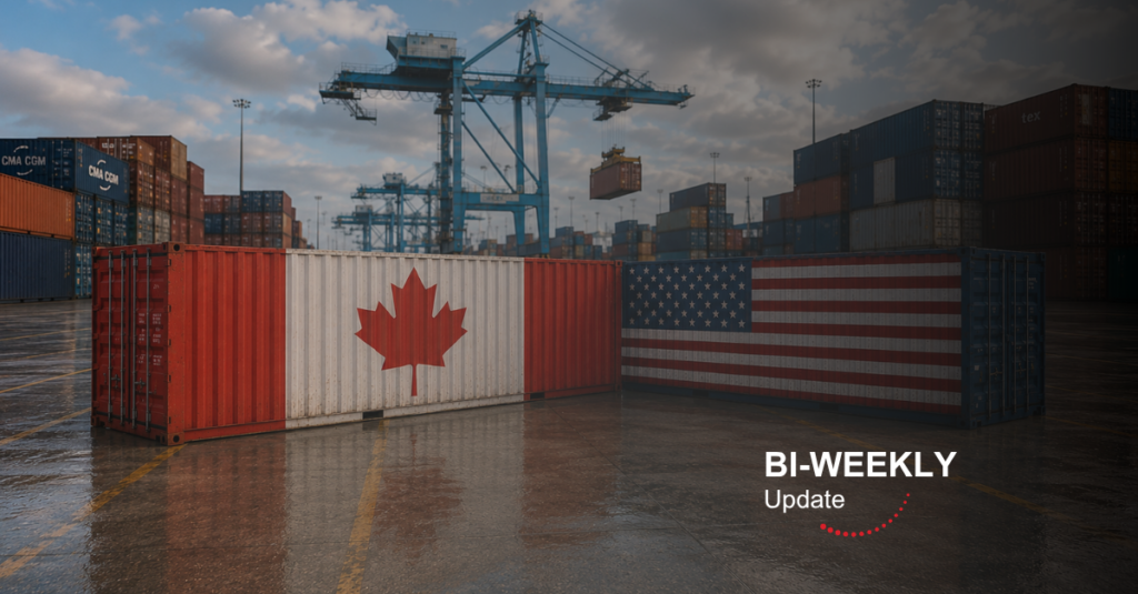 A cargo container yard with Canadian and U.S. flags displayed on shipping containers, surrounded by stacked containers and port cranes, representing Canada-U.S. trade and cross-border logistics.