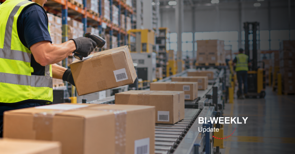 A warehouse worker scanning a cardboard box on a conveyor belt inside a modern distribution centre, with shelving, packages, and logistics equipment in the background. Overlay text reads “BI-WEEKLY Update” in the lower-right corner.